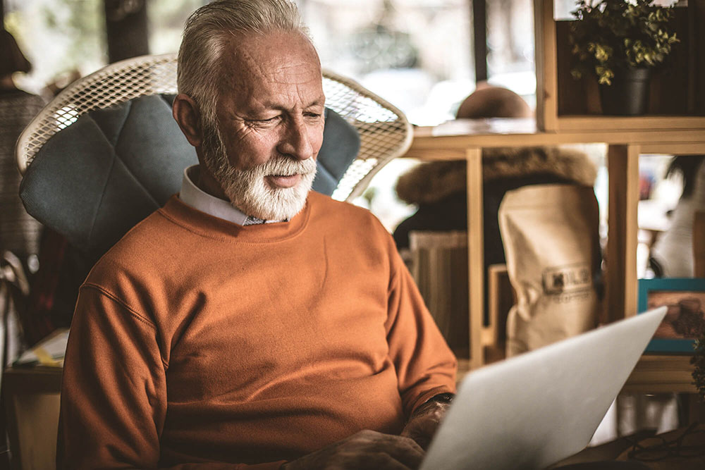 Retiree using a laptop in the living room